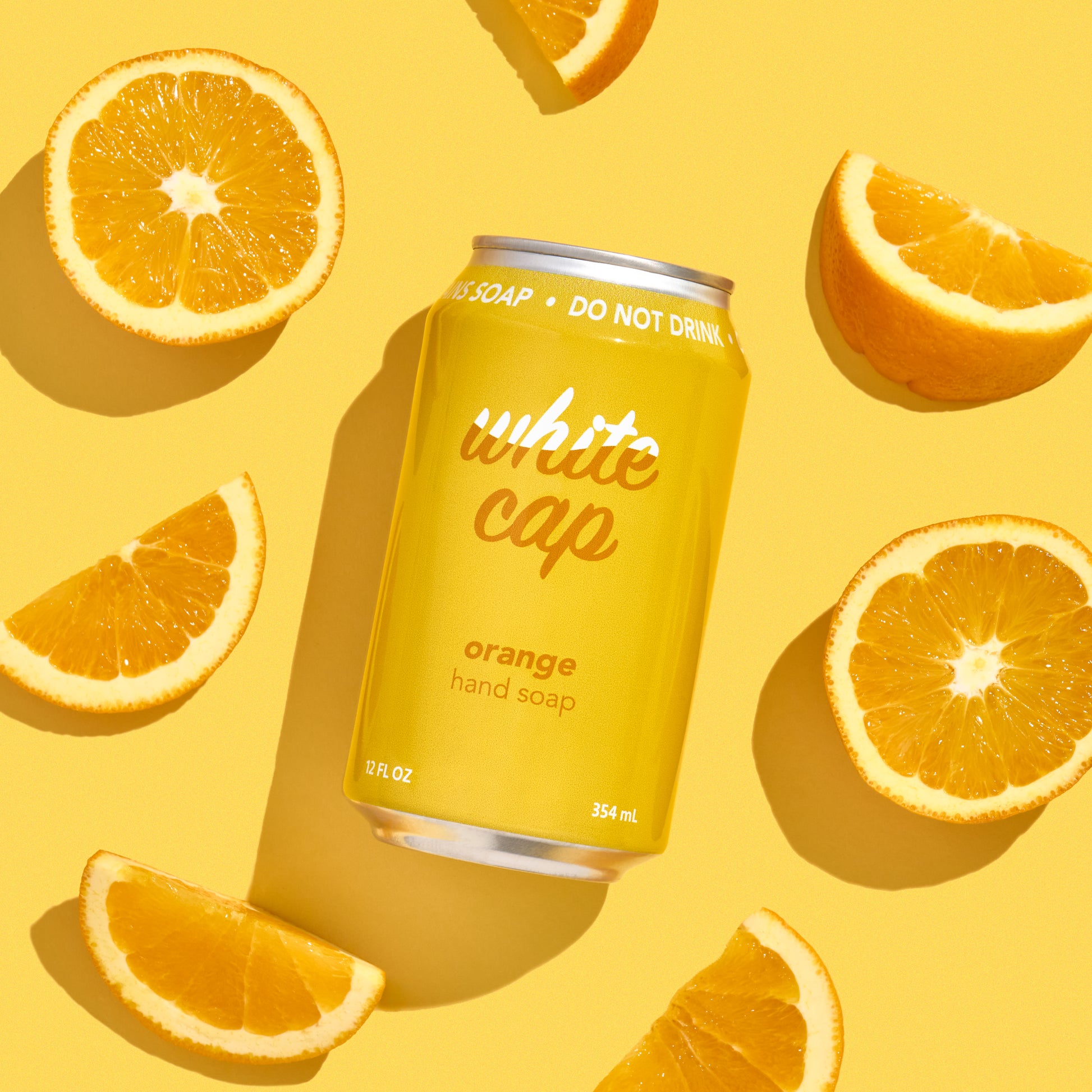 White Cap liquid orange hand soap in recyclable aluminum can.